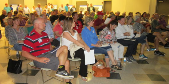 A crowd of over 100 listens as WSP/Parsons Brinckerhoff Senior Planner
Richard Odynski explains the challenges in developing improved traffic
flow within the Cornelius Highway 115 corridor.