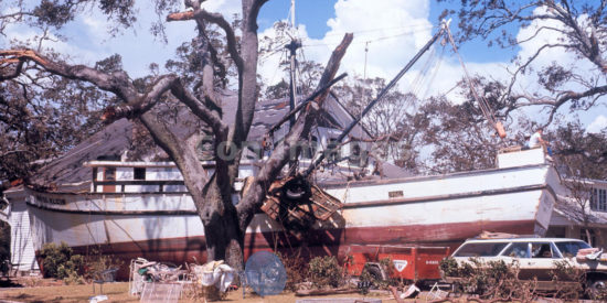 The aftermath of Hurricane Camille: large boat washed up in yard. Biloxi, Mississippi. Photo date: August 17, 1969.