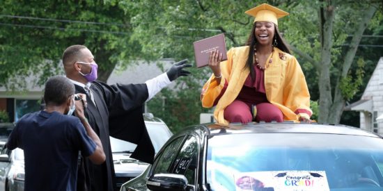 West Charlotte High School 2020 drive-through graduation, under pandemic safety protocol.  Graduates stayed in their cars and received diplomas from the principal as West Charlotte staff cheered for them.