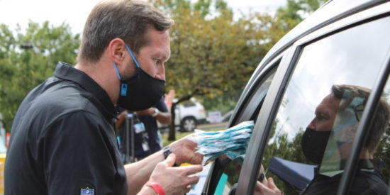 Carolina Panthers President Tom Glick distributes masks at the Atrium Health Million Mask Initiative.