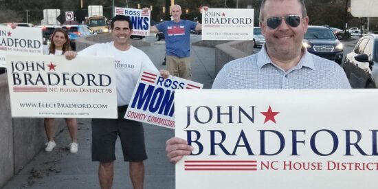Bradford on the I-77 bridge with supporters, including Joshua Dobi (foreground)