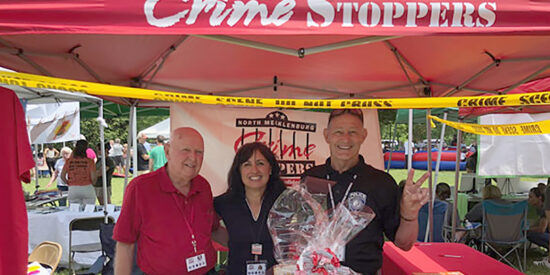 Tommy Davis, from left, historian for North Meck Crime Stoppers, Arlene Arciero, treasurer, and David Rochester, chairman, volunteer at an event. Crime Stoppers is a 
community-based program designed to assist local law enforcement agencies with crime prevention. 