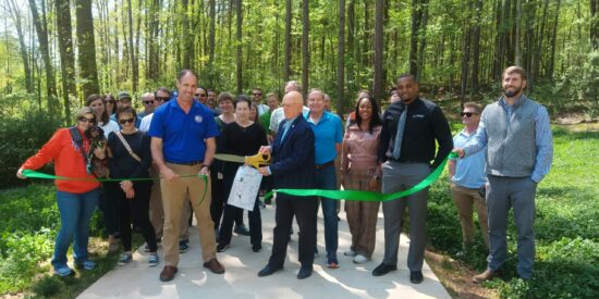 Mayyoor Washam cuts the ceremonial ribbon for Caldwell Station Tributary Greenway